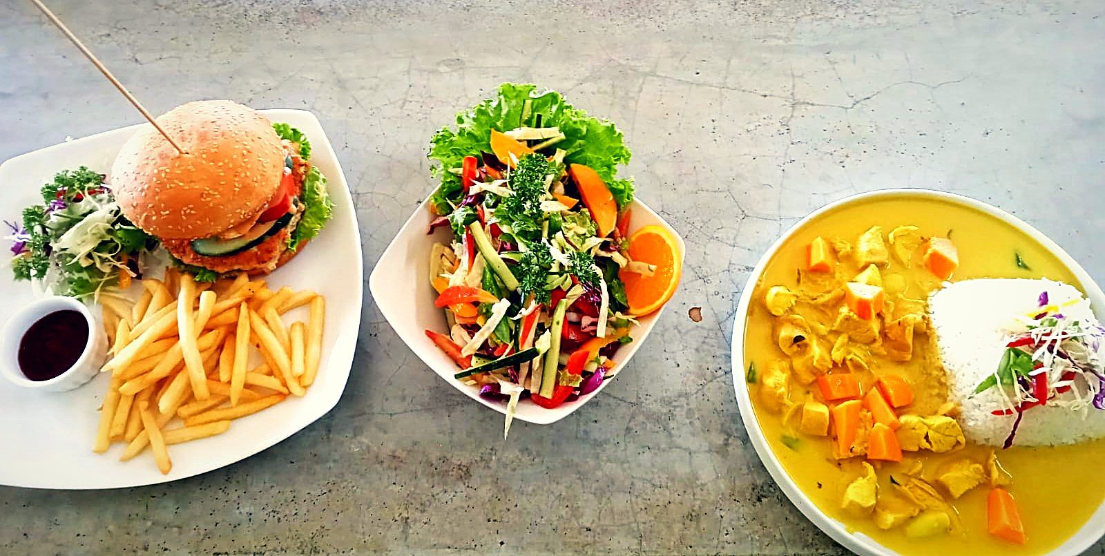 Burger with fresh salad and fruit
