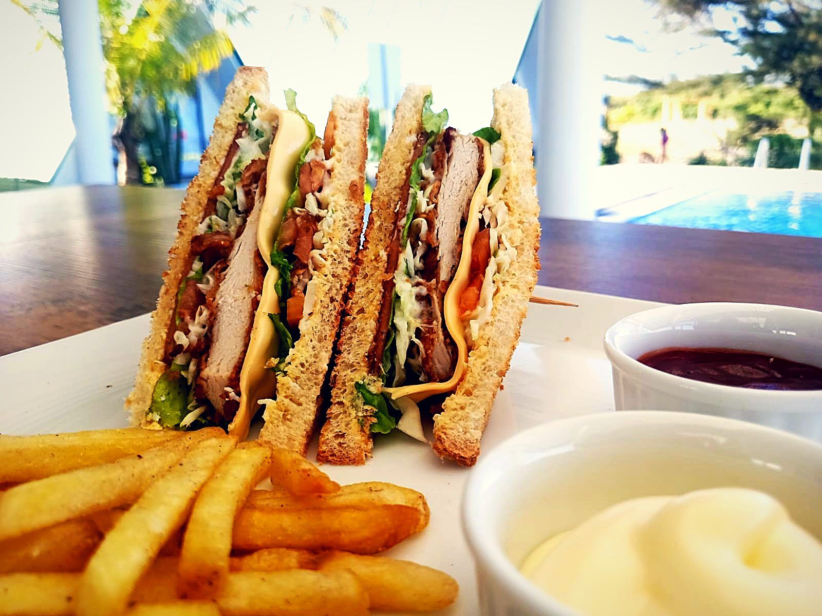 Club sandwich and fries poolside