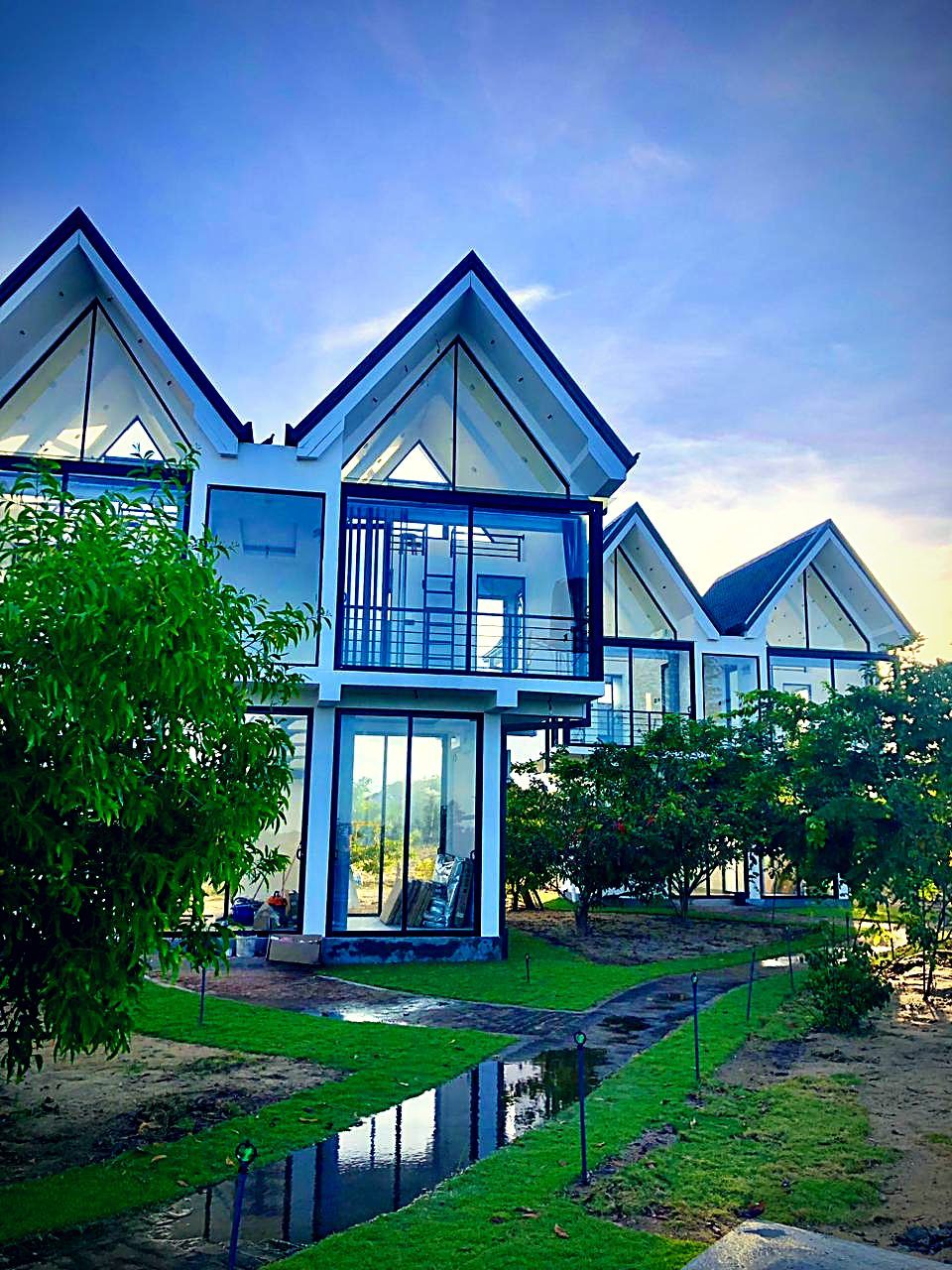 Timber A-frame villas among the garden